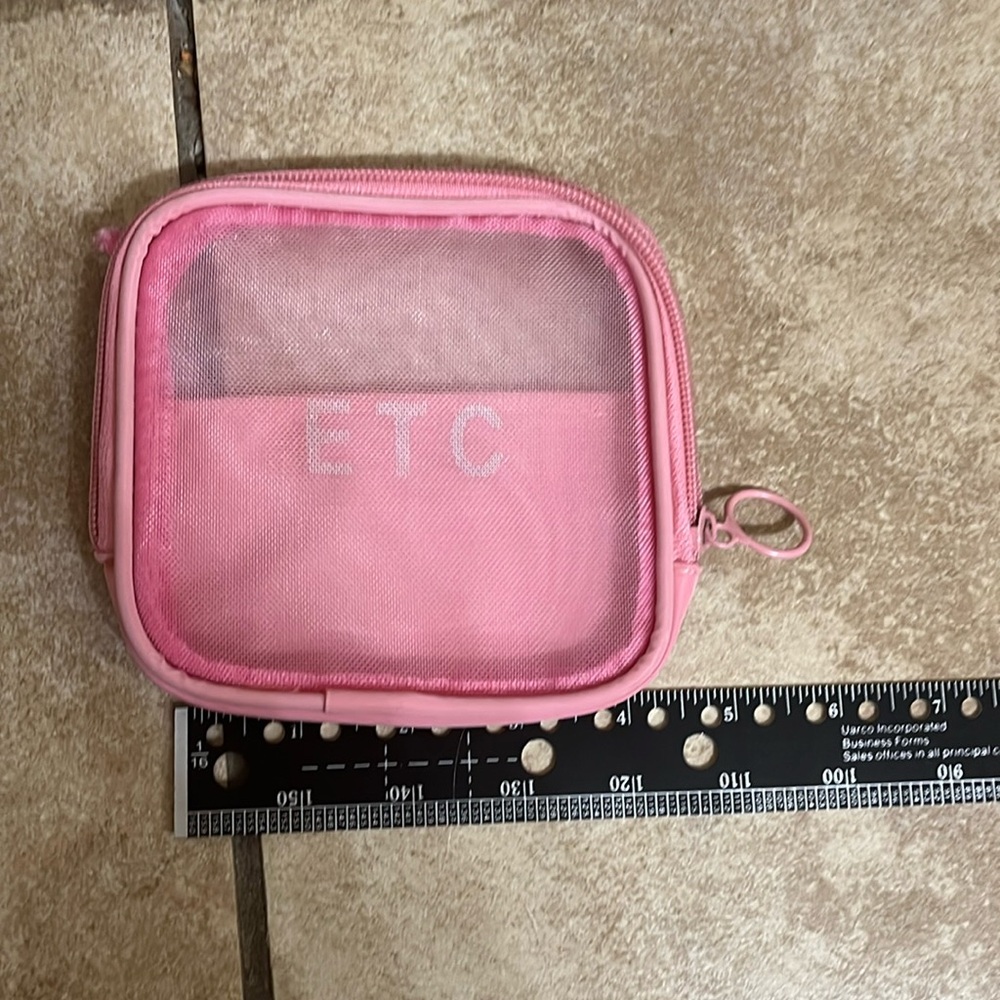 Small pink mesh travel pouch